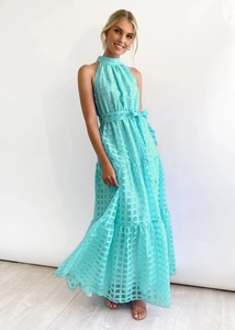 Close-up of turquoise plaid texture on a sleeveless high-neck tiered maxi dress
