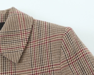 Close-up of lapel and shoulder tailoring on a brown houndstooth checkered blazer