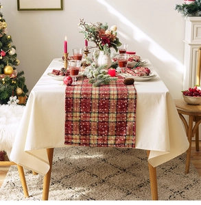 Close-up of red plaid table runner with snowflake patterns for Christmas table decor