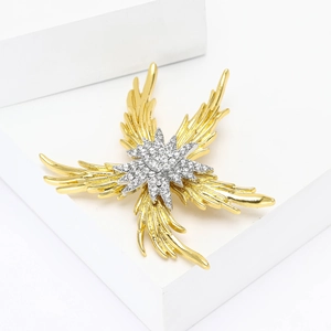 Elegant gold starfish brooch with sparkling crystals on a minimalist white pedestal