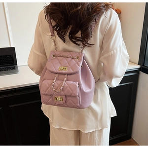 Detail of light purple quilted chain backpack with classic gold-tone twist lock and texture
