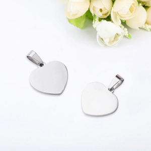 Polished heart shaped stainless steel pendants for DIY necklace jewelry on floral background