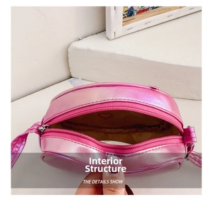 Detailed interior of pink metallic heart bag showing zipper and heart print lining