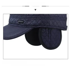 Close-up of diamond quilted windproof winter hat with ear flaps and metal detail