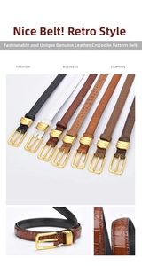 Detail of crocodile-patterned leather skinny belts with elegant gold pin buckles
