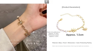 Detailed view of a gold-tone chain pearl bracelet with rhinestone star pendants