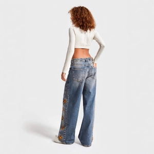 Women high waist wide leg blue jeans with orange floral embroidery cutout detailing