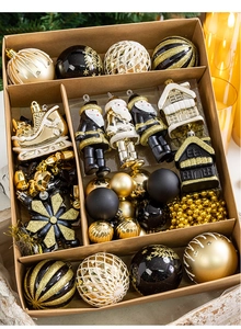Detailed set of gold and black Christmas ornaments in a gift box with a rustic background