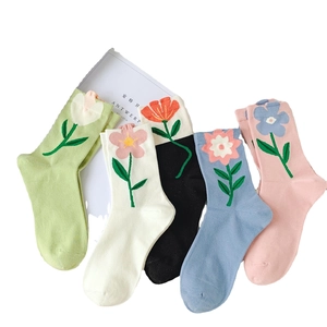 Five pairs of floral tulip crew socks in green, white, black, blue, and pink colors