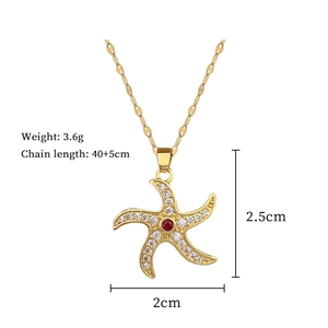 Golden starfish necklace detail with red stone, diamond inlay, and size measurements