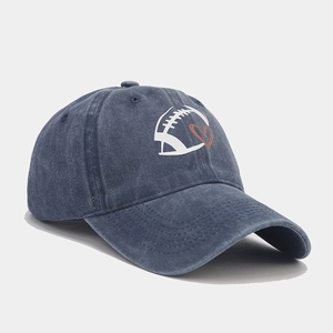 Classic washed navy cotton baseball cap with football and heart graphic in 45-degree view