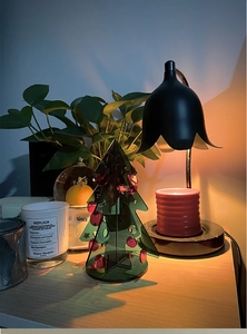 Black vintage lily of the valley candle warmer lamp on marble base with warm light