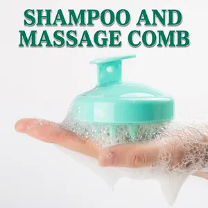 Mint green silicone scalp massage brush being held in hand with rich white soap lather
