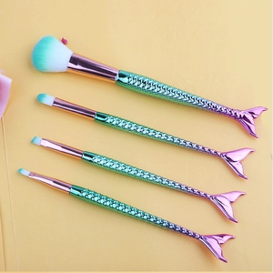 Detail of 4-piece mermaid makeup brush set with green-purple gradient scale handles