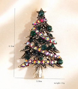 Detail of Christmas tree brooch with green crystals and measurements 4.5cm by 3.0cm