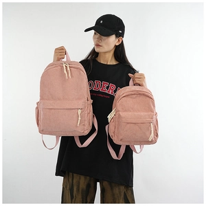 Pink corduroy backpack shown in large and small sizes for scale comparison