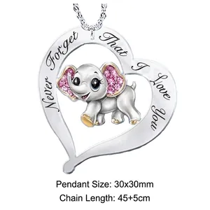 Detail view of heart-shaped elephant pendant with engraved message and pink stones
