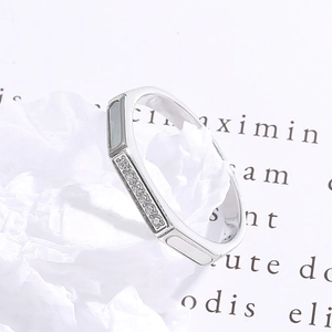 Macro shot of silver octagonal ring with micro-pave crystals and white shell inlays