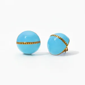 Detailed macro view of blue enamel half-ball earrings with a gold chain-link inlay