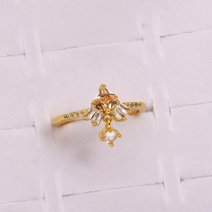 Macro shot of gold ring with champagne zircon and flower-shaped crystal arrangement