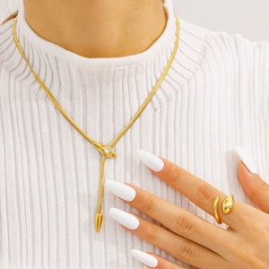 Elegant gold snake jewelry set with a zircon necklace and matching ring on a model