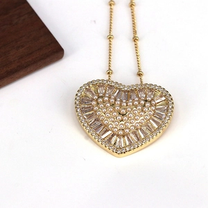 Elegant gold heart pendant necklace with white pearls and sparkling cubic zirconia stones
