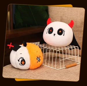Detail of plush Halloween ghost and pumpkin devil pillows on a beige sofa