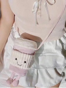 Detailed view of pink plush coffee cup crossbody bag with cute embroidery and small legs
