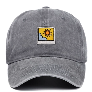Washed grey cotton baseball cap featuring embroidered minimalist sun and cloud patch
