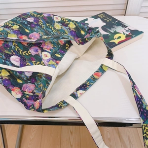 Detailed top view of a floral canvas tote bag with colorful oil painting print pattern