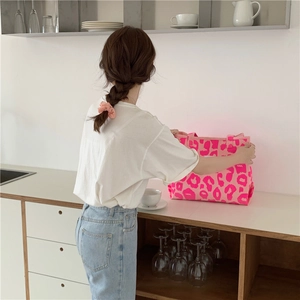 Close-up of pink leopard print canvas tote bag in a minimalist kitchen setting