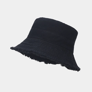 Detail view of cotton canvas bucket hat featuring frayed edges and vintage raw hem design