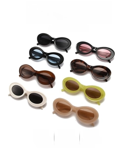 Detailed flat lay of retro oval sunglasses in multiple colors on a clean white background