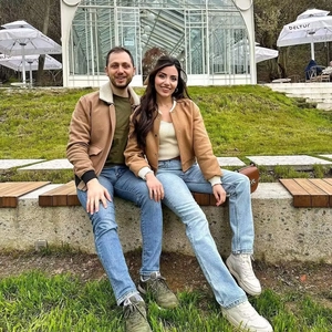 Outdoor shot of couple wearing khaki biker bomber jackets with contrast pocket details