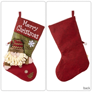 Detail of red and green Christmas stocking with 3D Santa Claus and Merry Christmas embroidery