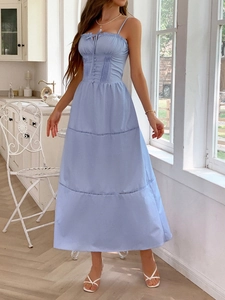 Elegant light blue tiered maxi dress with spaghetti straps and lace trim in a vintage kitchen