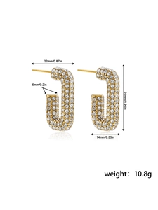 Detailed view of U-shaped gold earrings with dimensions 24mm by 14mm and clear rhinestones