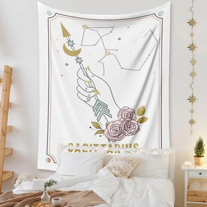 Detail of bohemian Sagittarius tapestry featuring gold moon, arrows, and pink roses