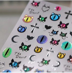 Macro view of 3D embossed nail stickers featuring evil eye, cross, and crescent moon motifs