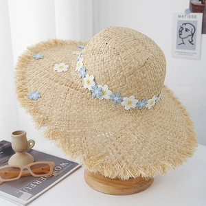 Summer raffia straw hat with delicate floral embroidery and frayed brim for sun protection