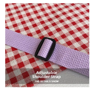 Close-up of adjustable purple nylon shoulder strap with durable black plastic buckle