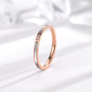 Minimalist 18k rose gold titanium ring featuring white shell inlay and a center diamond