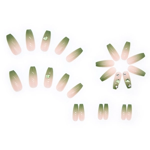 Press-on nails featuring green aurora gradient with heart gems and rhinestone accents