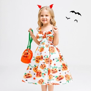 Detail of girls pumpkin print Halloween dress with matching bat clip and treat bag