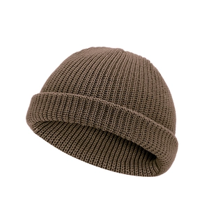 Detail of brown ribbed knit beanie with high-elasticity retro texture on white background