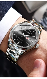 Close-up of luxury black dial quartz watch with day-date window and diamond hour markers