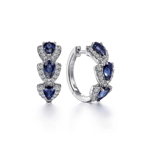 Detailed view of silver hoop earrings featuring blue pear-cut zircon and pave diamonds