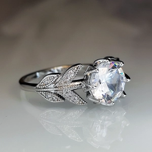 Elegant silver crown ring with leaf pattern and round brilliant cut cubic zirconia