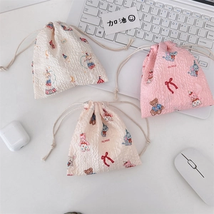 Detail of seersucker drawstring pouch with cute circus animal patterns and ruffles