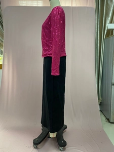 Detail of rose red sequin jacket with shiny finish and stand-up collar design
